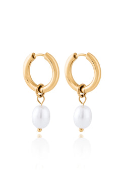 Gold hoop earrings with white pearls on a white background