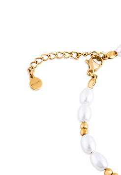 Gold bracelet with white pearls on a white background