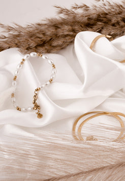 Bracelet on a white fabric with a fur background