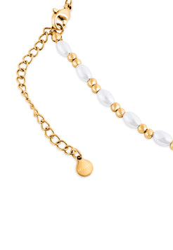 Bracelet with gold chain and white beads on a white background