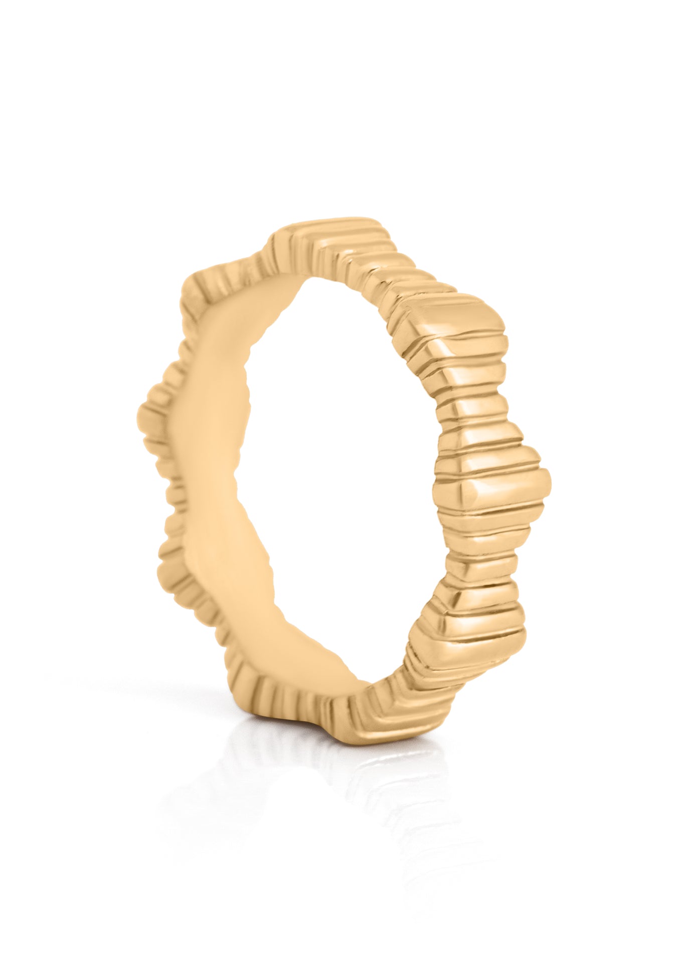 Gold ring with textured design on a white background