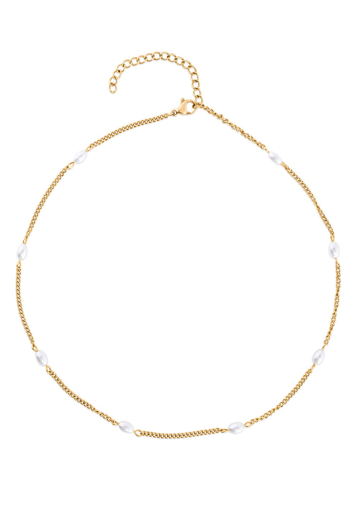 Gold necklace with white beads on a white background