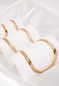 White bra with gold trim on a white background