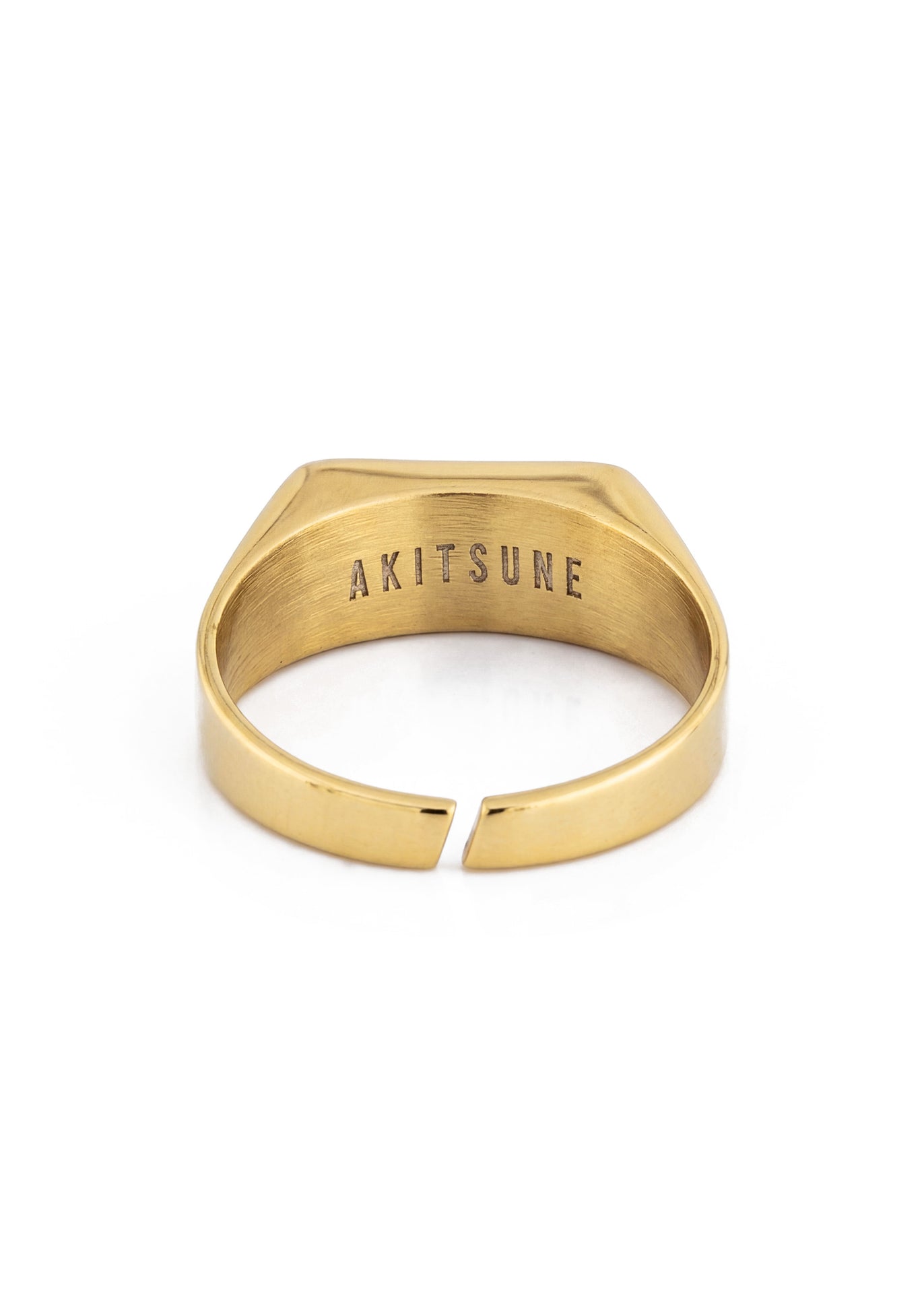 Gold ring with 'AKITSUNE' engraving on a white background