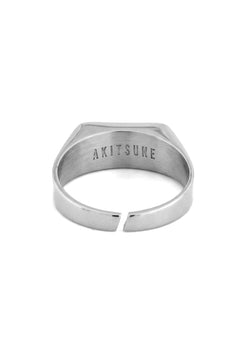 Silver ring with 'AKITSUNE' engraving on a white background