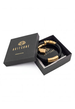 Black and gold bracelet in a black box with 'Akitune' branding on a white background