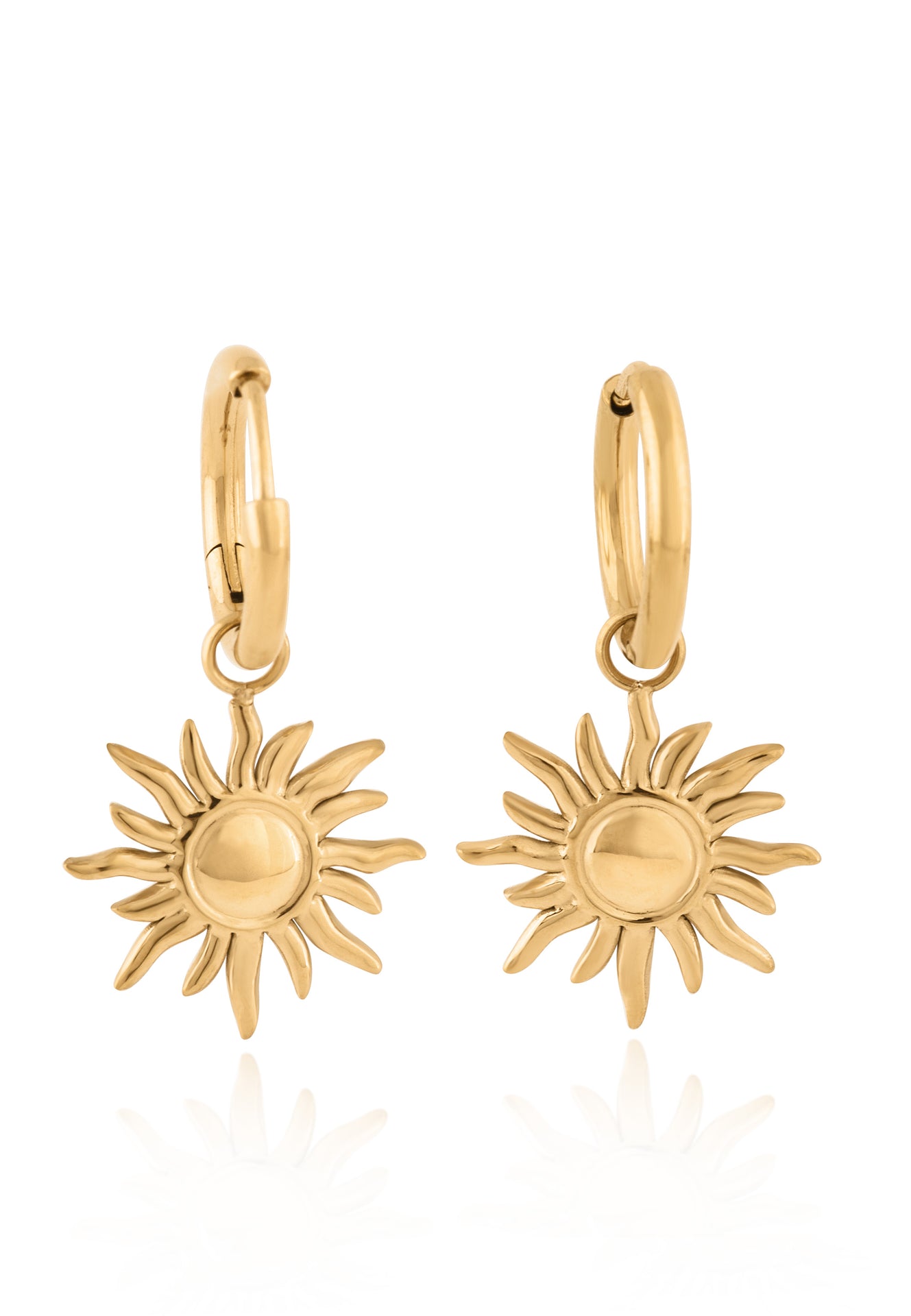 Gold sun-shaped earrings on a white background