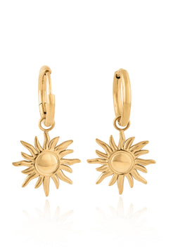 Gold sun-shaped earrings on a white background