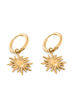 Gold hoop earrings with sun-shaped charms on a white background