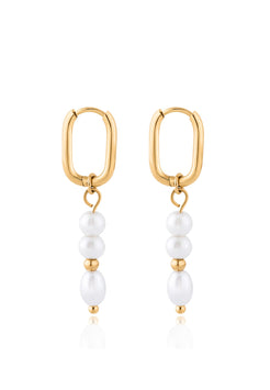 Gold hoop earrings with pearl drops on a white background
