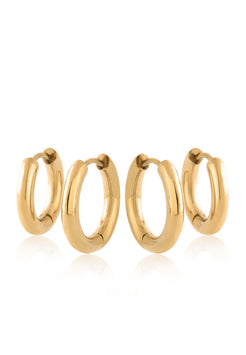 Set of gold hoop earrings on a white background