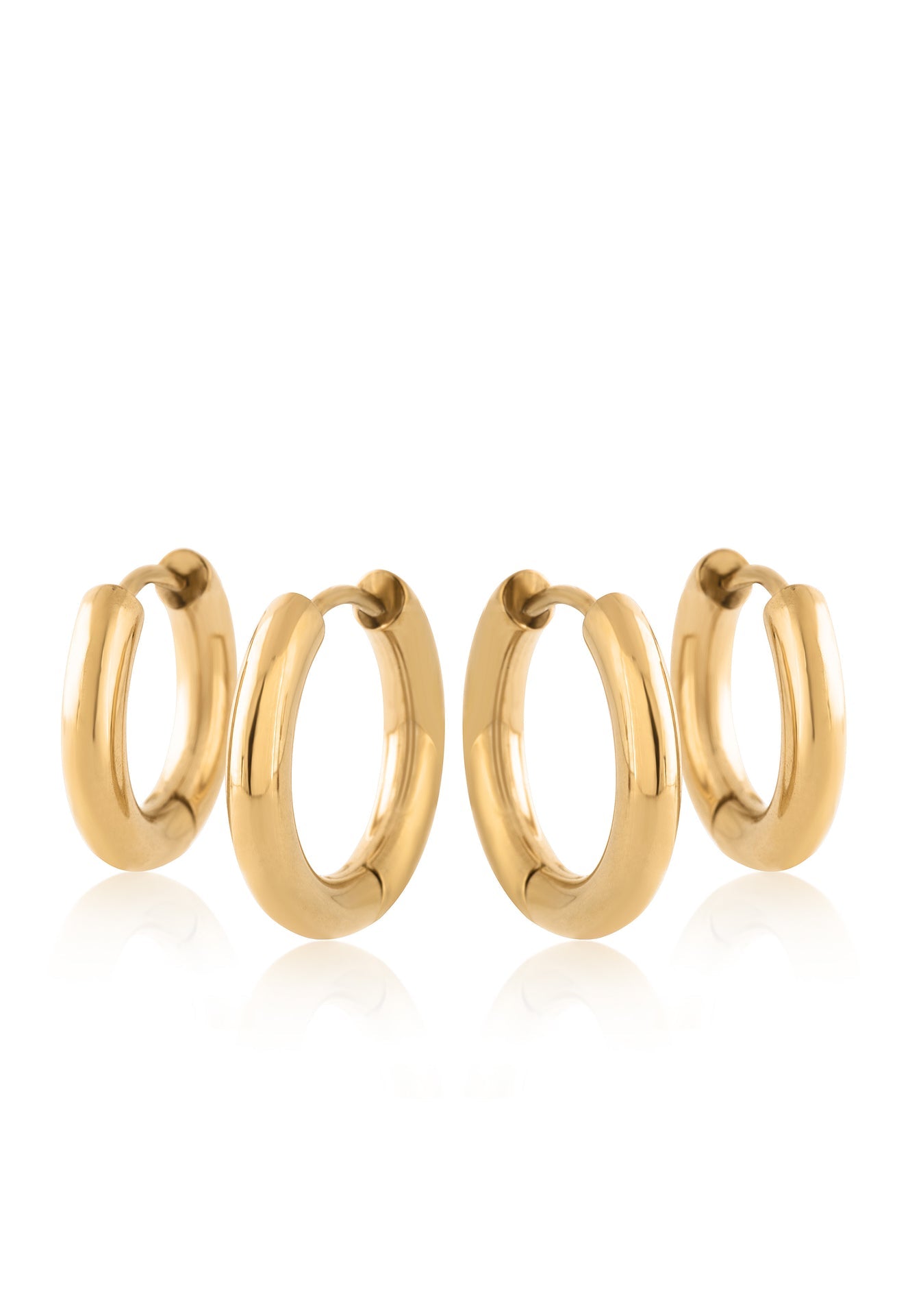Set of gold hoop earrings on a white background