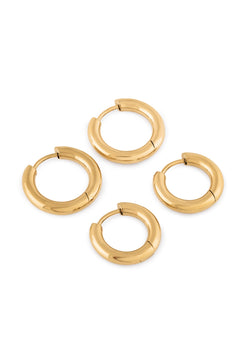 Set of gold hoop earrings on a white background