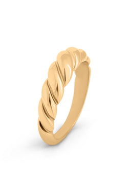 Gold ring with a twisted design on a white background