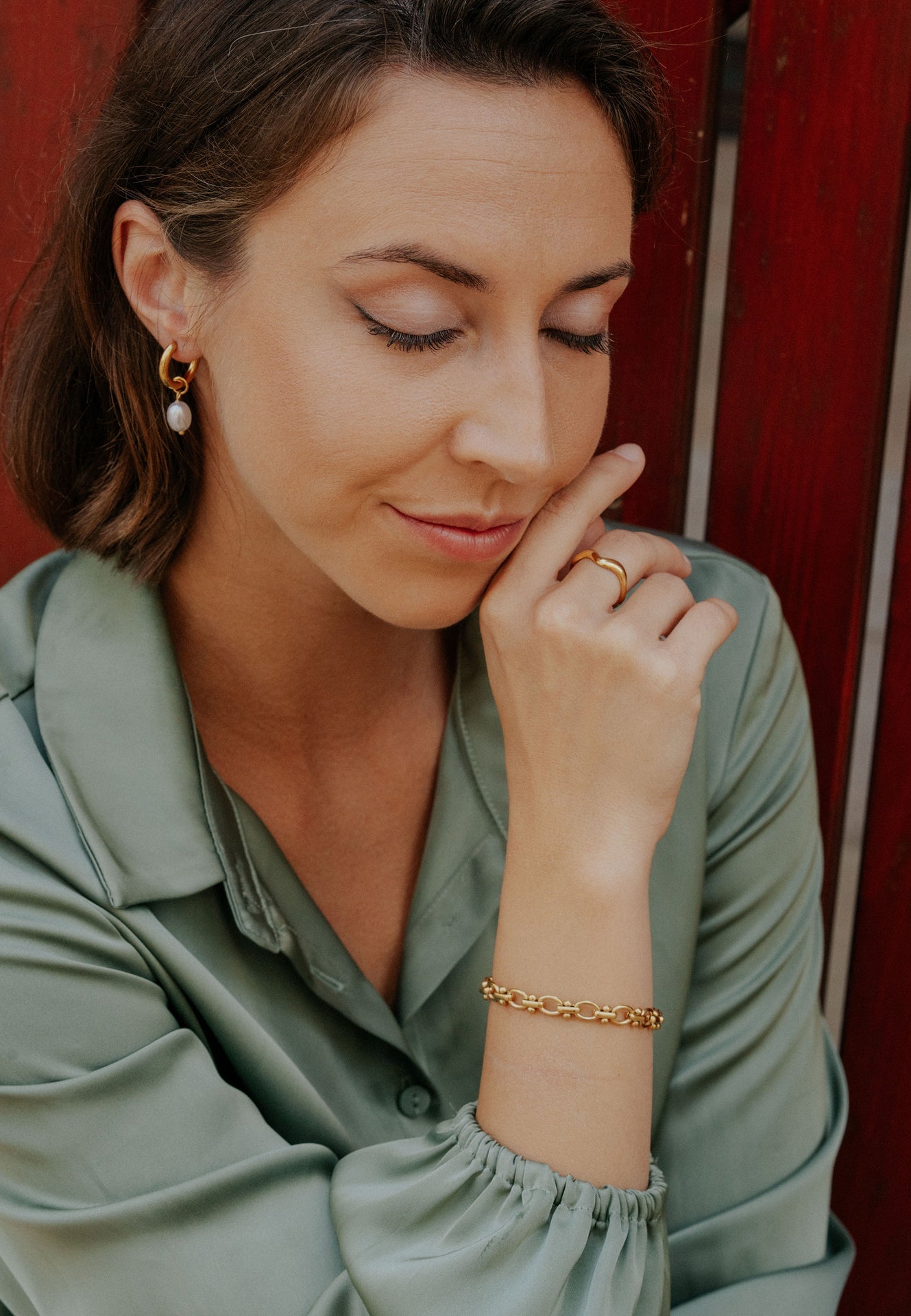 Woman wearing a green shirt with a red background