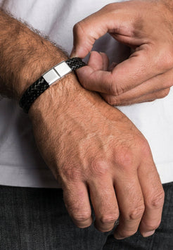 Model wearing Akitsune Simplicitas silver and black leather bracelet, showcasing a minimalist handcrafted design with premium leather and sleek metal details.