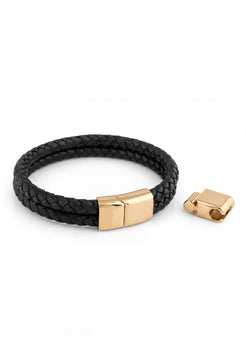 Akitsune Simplicitas gold and black leather bracelet with logo detail, featuring a minimalist handcrafted design, premium black leather strap, and refined gold-tone hardware.
