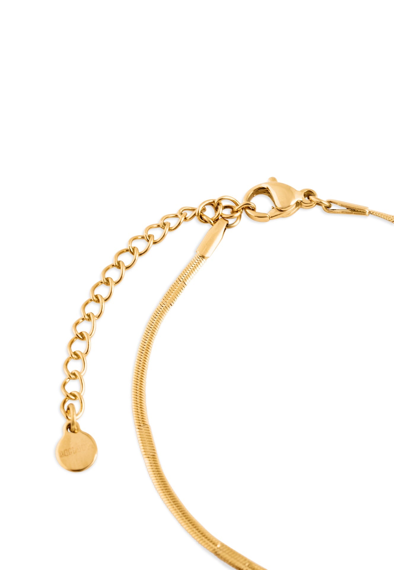 Gold bracelet with a small round charm on a white background
