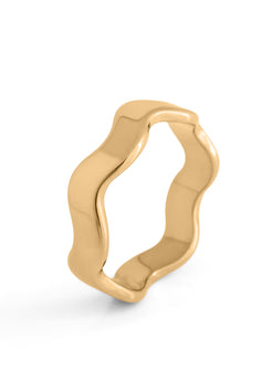 Gold ring with wavy design on a white background